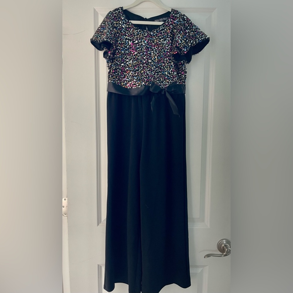 Rainbow color sequence top with black pants bottom, one piece.